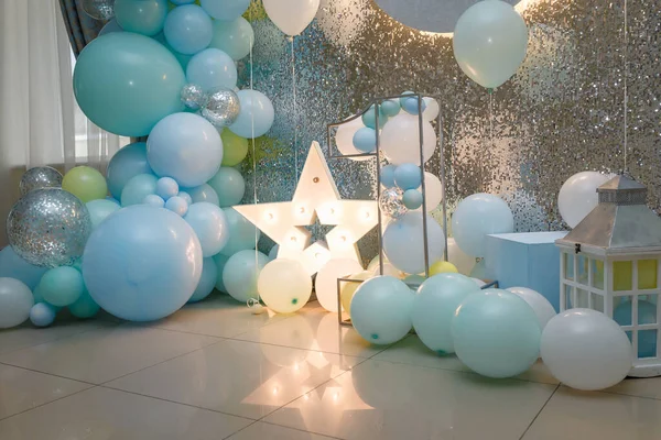 Arch of blue balloons for boy happy birthday party. Number 1 for one year old baby. Festive decorative elements, star, photo zone.