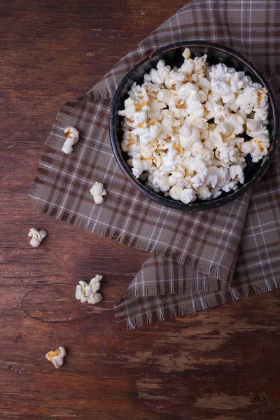 Haufen Popcorn Schwarzer Schüssel Auf Rustikalem Holzgrund Einige Popcorn Auf — Stockfoto