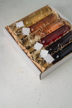Tahta talaş kutusunda 250 ml kırmızı, pembe, beyaz şarap var. Etiketi yok. Hediye ya da kutlama için içki seti