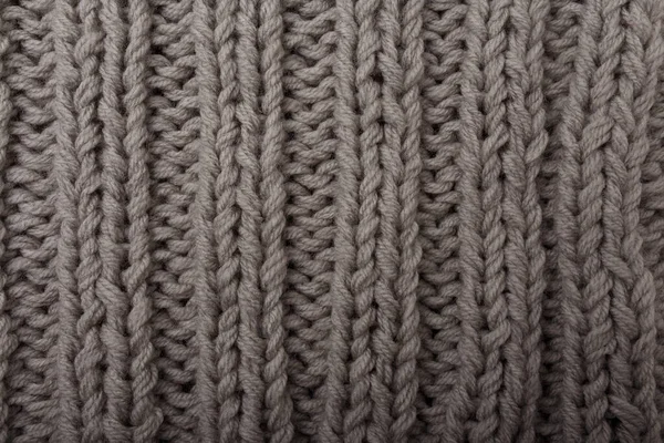 Gri kumaş dokusu, arkaplan ya da fon örgüsü. Tekstil, atkı ya da süveter desenli yüzey. Sıcak aksesuarlar, kıyafetler, moda konsepti.