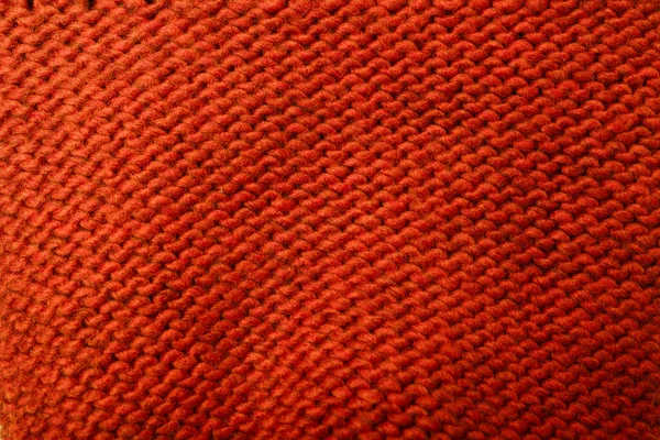 Kırmızı kumaş dokusu, arkaplan ya da arkaplan örer. Tekstil, atkı ya da süveter desenli yüzey, arka ya da yanlış taraf. Sıcak aksesuarlar, giysiler.