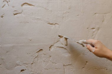 Duvarda macun kullanan spatula kullanan erkek eller, tadilat yapan inşaatçılar..