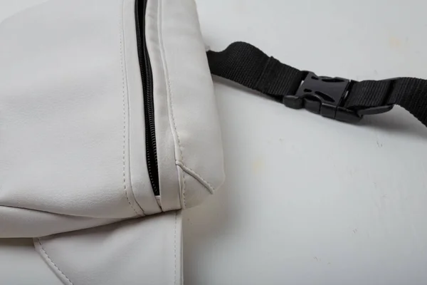 Eco leather waist bag with black zipper on white background, close up shot
