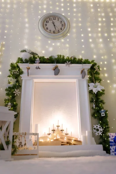 Decorative Christmas Fireplace Fir Branches Candles Wood Garlands Clock White — Stock Photo, Image