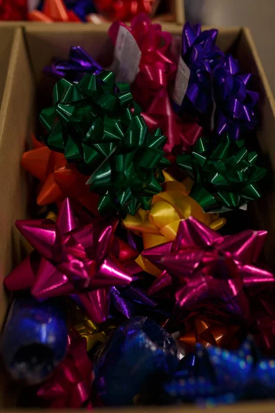 Bright shiny bows for presents boxes wrapping in a carton in shop, store or supermarket. Decorative elements for birthday party celebration