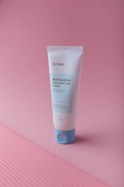 Izmail, Ukraine. March 2022. IUNIK Beta-glucan daily moisture cream, brightening and wrinkle care. Skin Korean cosmetics. Tube on pink
