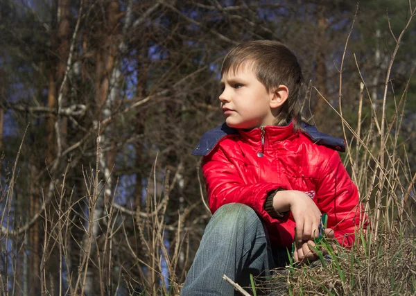 Boy in jacket looking into the distance — Stock Photo, Image