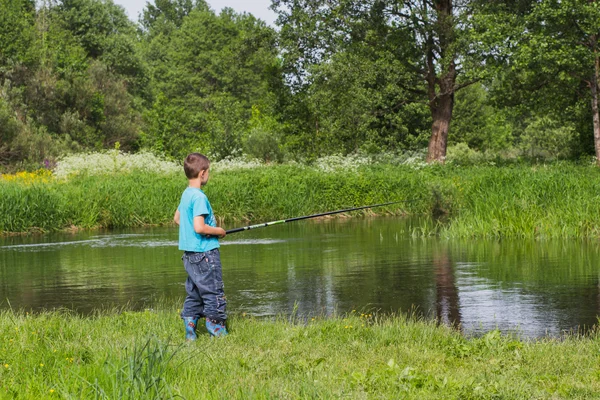 Junge mit Angelrute am Ufer des Flusses — Stockfoto