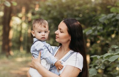Mutlu genç anne oynuyor ve oğluyla eğleniyor.