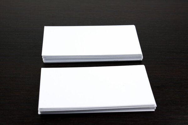 White business cards on wooden surface ideal for mockup