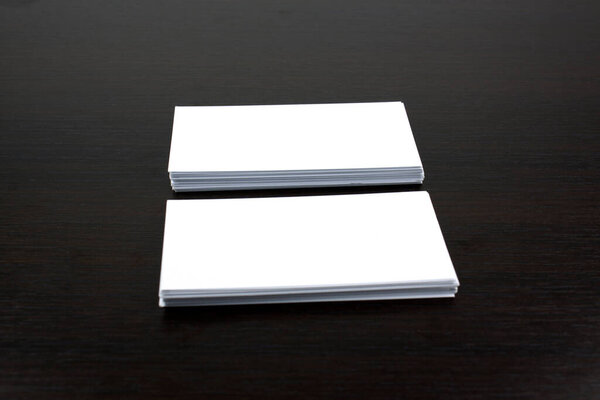 White business cards on wooden surface ideal for mockup