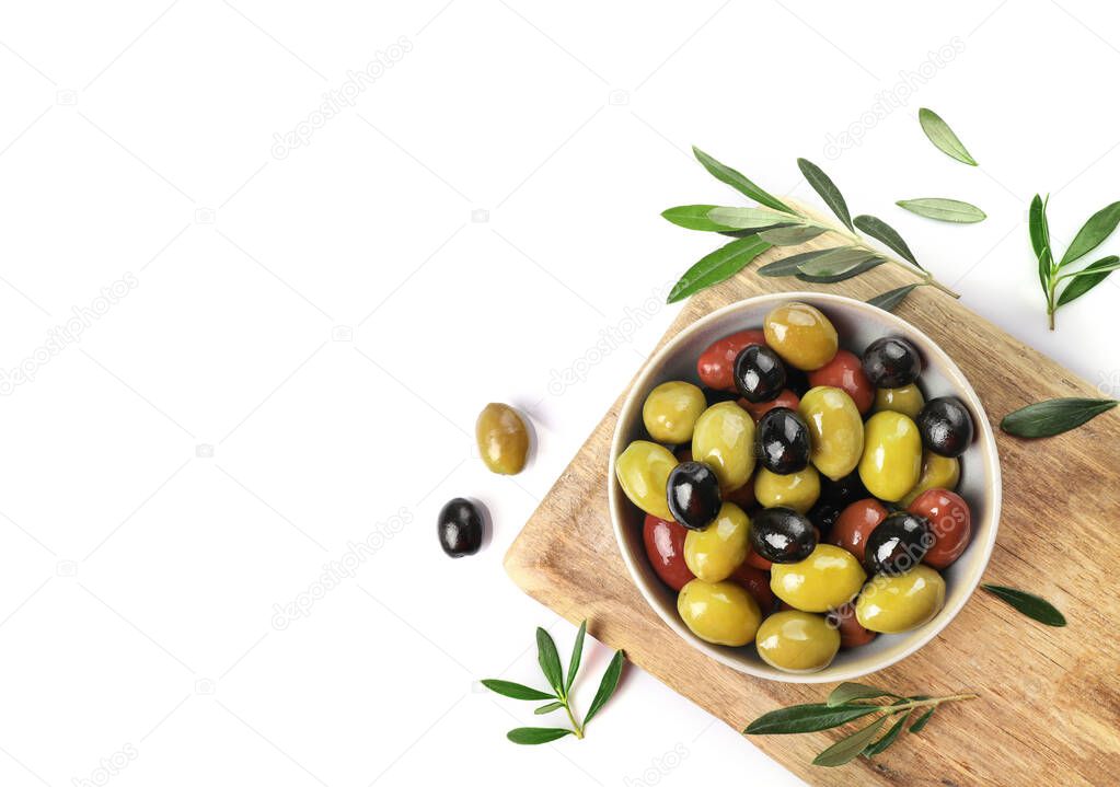 Green, red and black olives in a bowl isolated on white background