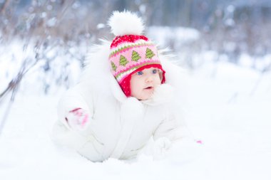 Karda oynarken güzel mavi gözlü kız bebek