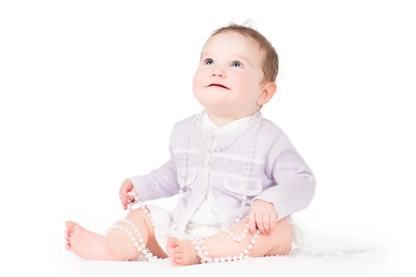 Girl playing with pearls — Stock Photo, Image