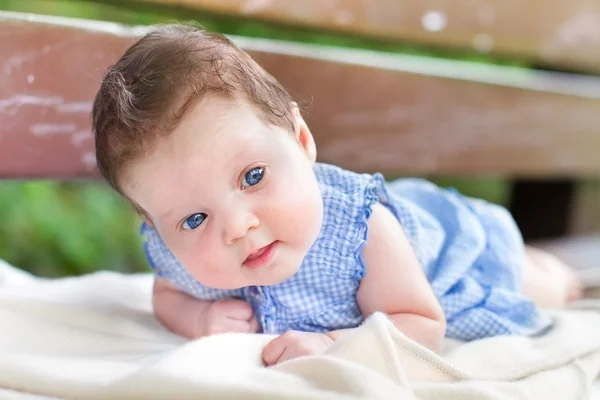 Baby girl relaxing on his tummy — Stok Foto