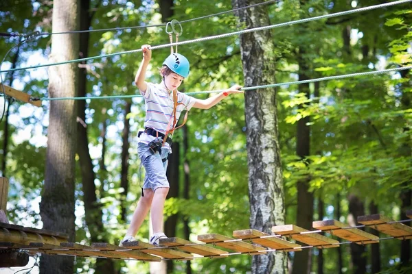 Skola pojke i en klättring aktivitet park — Stockfoto