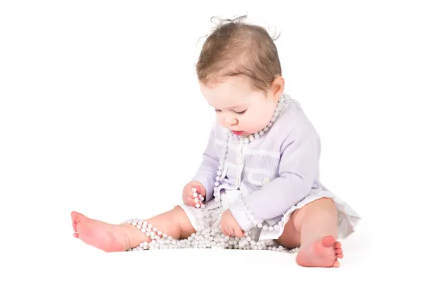Girl playing with pearls — Stock Photo, Image