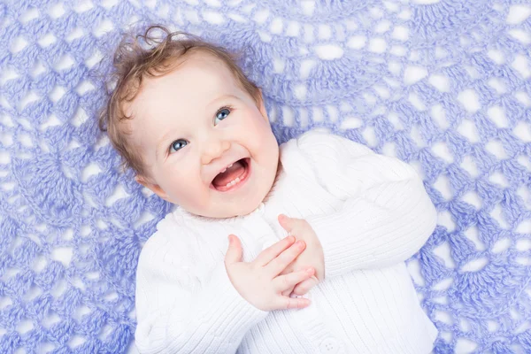 Little baby on a hand made knitted blanket