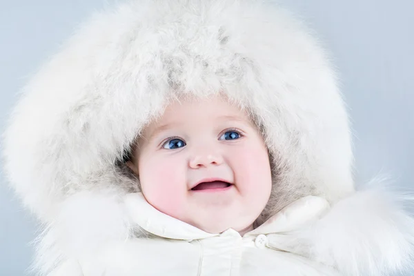 Baby girl wearing a big fur hat — Stock Photo, Image