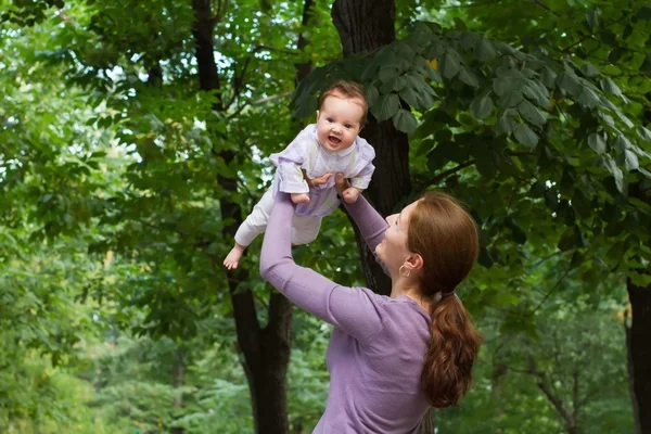 Mother playing with a laughing baby girl — Stock Photo, Image