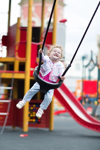 Girl enjoying a swing ride — Stock Photo, Image