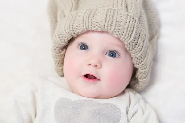 Little baby in a huge knitted hat — Stock Photo, Image