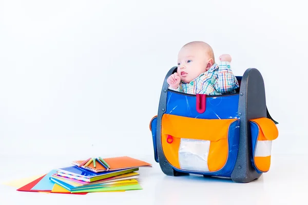 Newborn baby in a big school bag — Stock Photo, Image