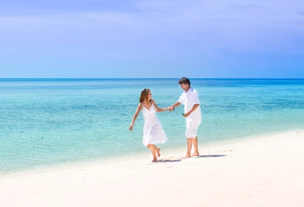 Paar draait op een tropisch strand — Stockfoto