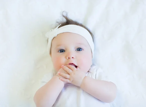 Cute baby girl with white bow — Stock Photo, Image