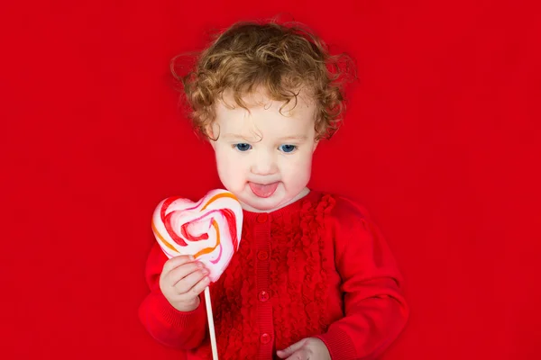 Baby girl with a candy — Stock Photo, Image