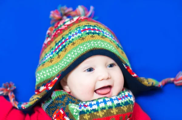 Baby wearing a funny knitted hat and scarf — Stock Photo, Image