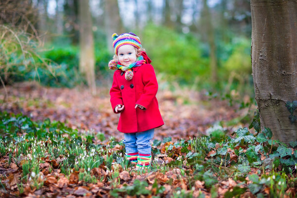 Тоддлер играет в весеннем парке
