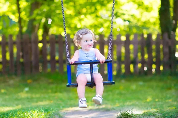 Happy laughing toddler girlenjoying a swing ride — Stock Photo, Image