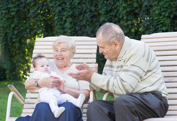 Grandparents playing with a little baby — Stock Photo, Image