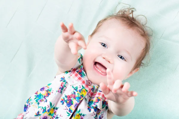 Baby girl on a green knitted blanket — Stock Photo, Image