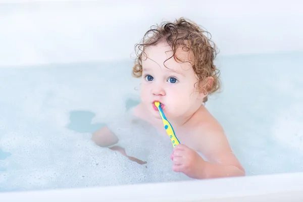Baby with beautiful blue eyes and curly hair taking bath — Stock Photo, Image