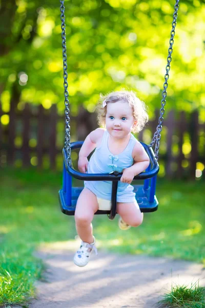 Happy laughing toddler girlenjoying a swing ride — Stock Photo, Image