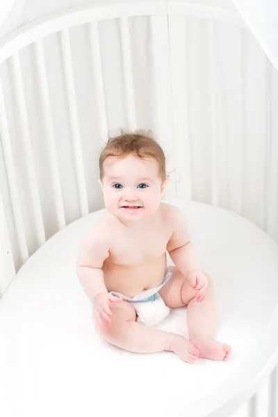 Funny baby  playing in its crib — Stock Photo, Image