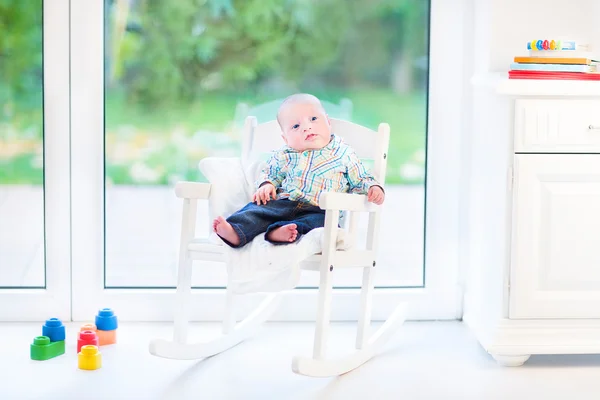 Newborn baby boy in a white rocking chair — Stock Photo, Image