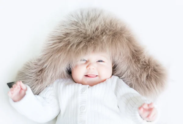 Baby wearing a big fur hat — Stock Photo, Image