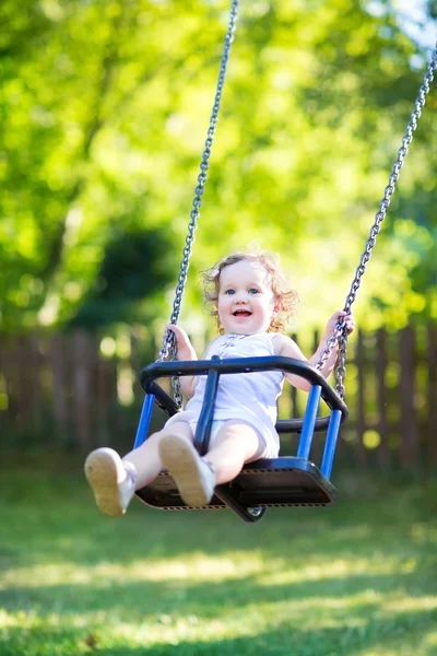 Girl having fun on a swing ride — Stock Photo, Image