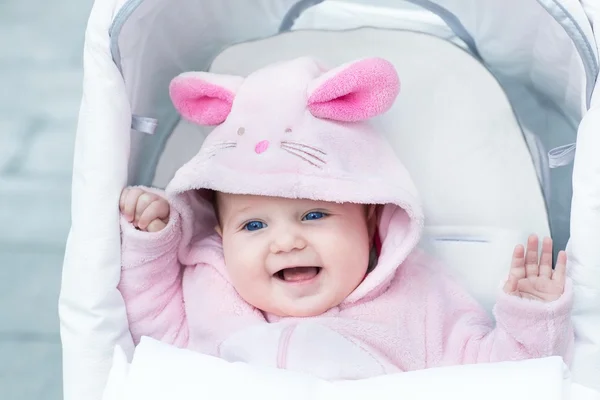 Baby girl enjoying a stroller ride on a cold winte — Stock Photo, Image