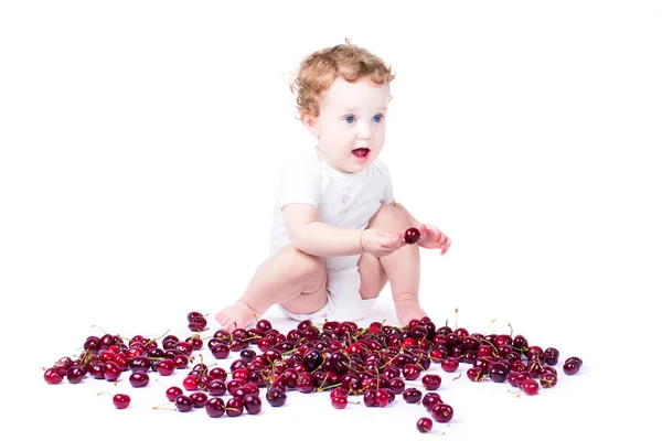 Baby girl eating red cherry — Stock Photo, Image