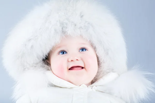 Baby girl wearing a huge white fur hat — Stock Photo, Image