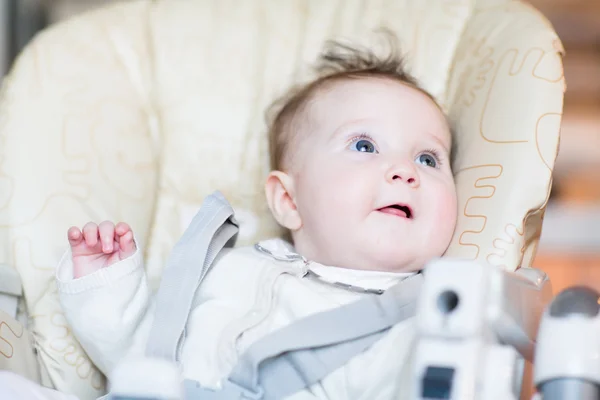 Baby girl waiting for dinner in a high chair — Stock Photo, Image