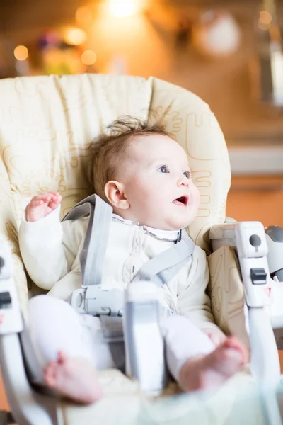 Baby in a high chair — Stock Photo, Image