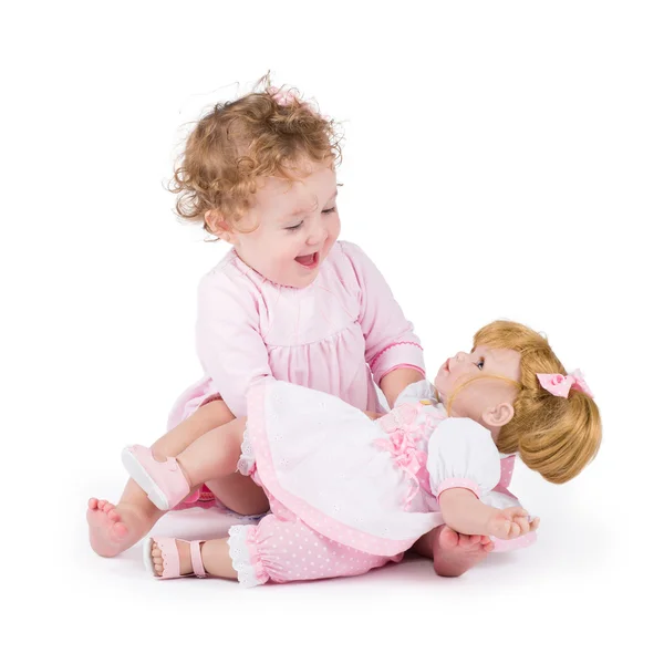 Menina brincando com sua primeira boneca — Fotografia de Stock