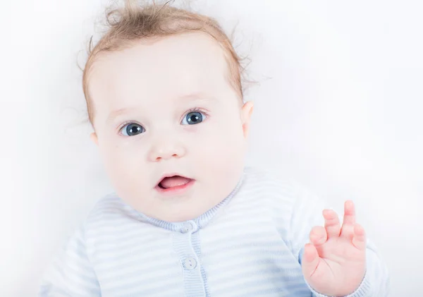 Little baby in a blue knitted sweater — Stockfoto