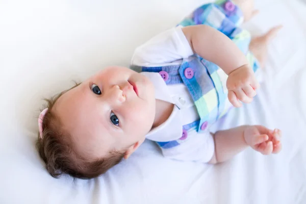 Baby girl in purple overalls — Stock Photo, Image