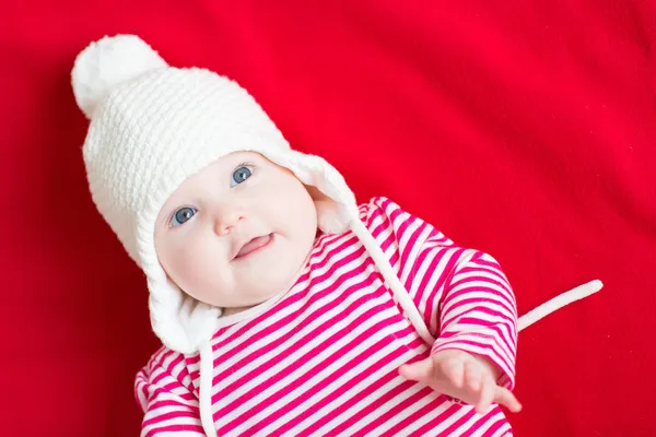 Baby girl wearing a white knitted hat — Stock Photo, Image